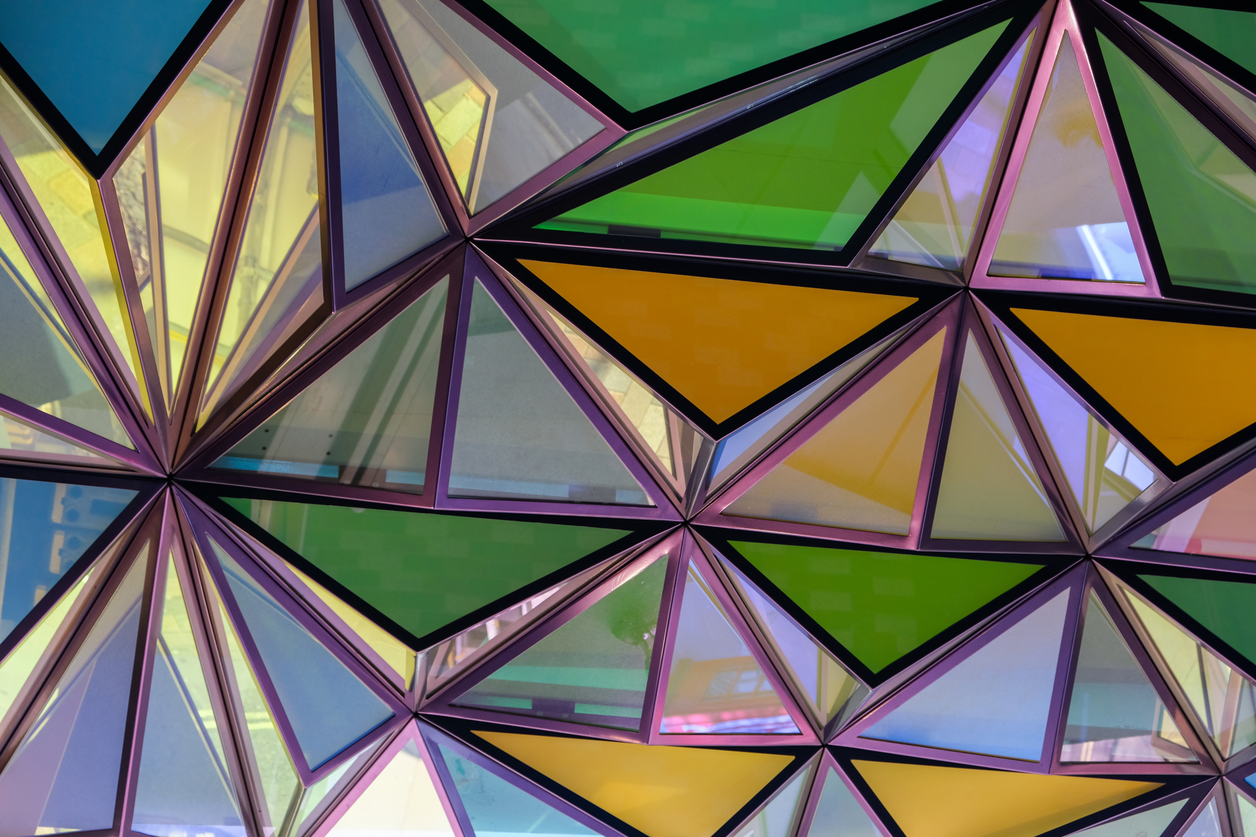 Colourful triangular patterned glass roof.