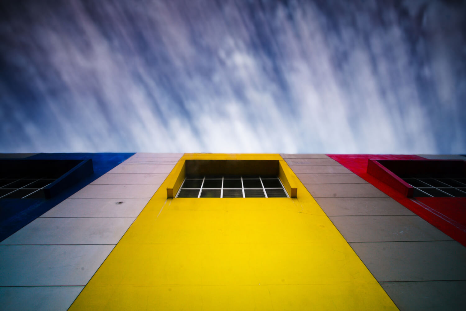 Blue, Yellow and Red stripes on a building wall